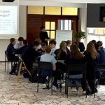 Uczniowie w klasie słuchają prezentacji na temat depresji wyświetlanej na ekranie z przodu.